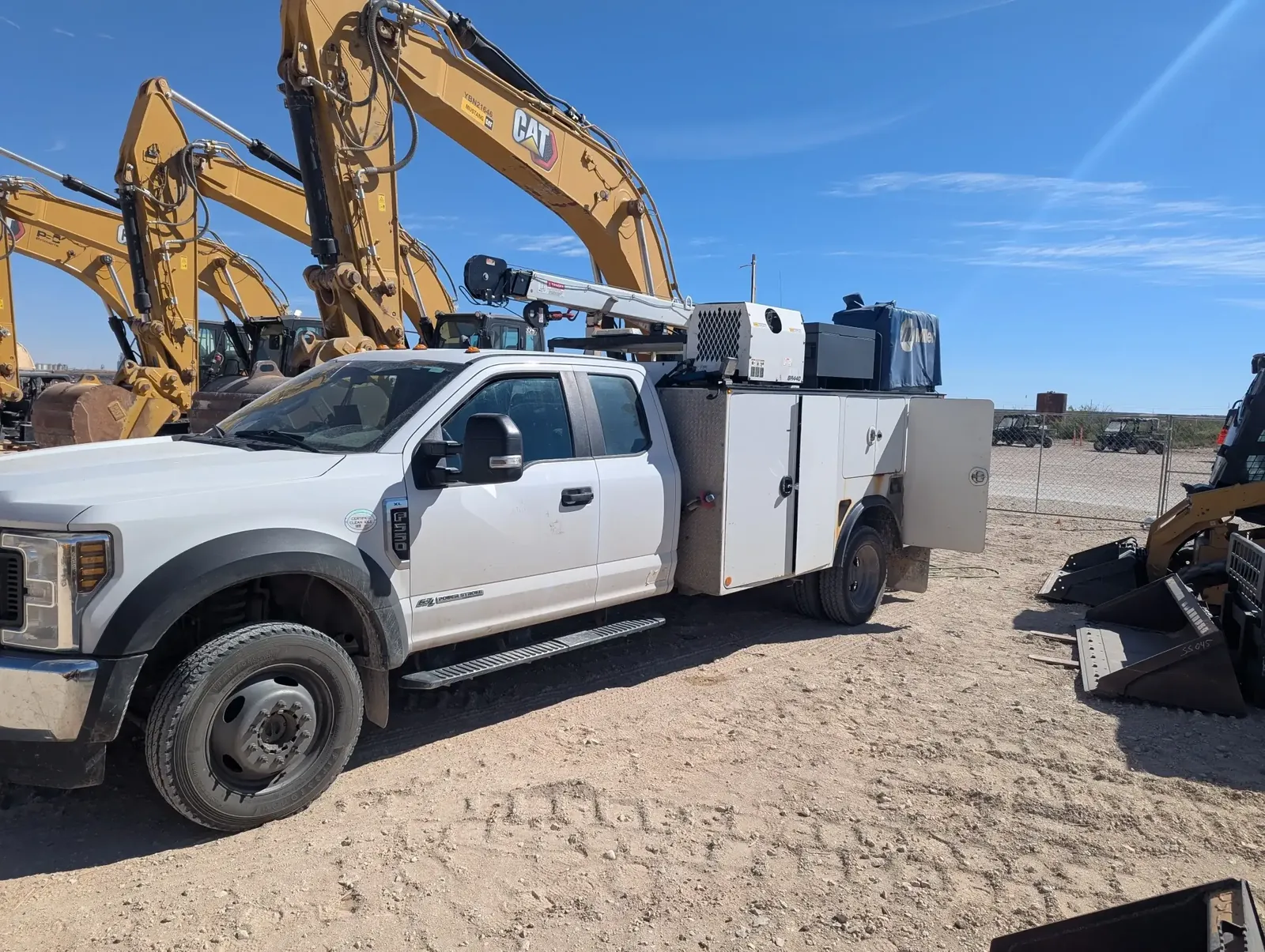 JRD Equipment Service field service truck parked beside Caterpillar excavators at a jobsite in central Illinois